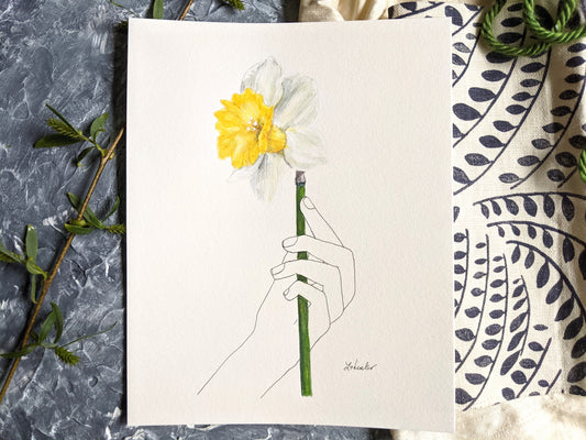 line drawn hand holding a watercolor daffodil